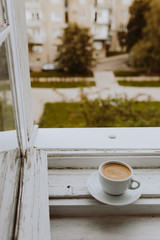 A cup of coffee by the window