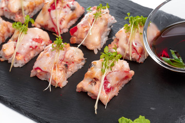 Black rectangle plate with sushi, isolated on white