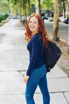 Happy young redhead woman with a vivacious smile