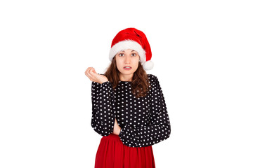Portrait of disappointed pissed cute female in dress. emotional girl in santa claus christmas hat isolated on white background. holiday concept