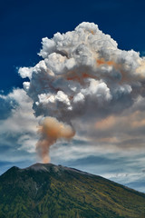 29 June 2018, Bali, Indonesia.Mount Agung volcano dramatic eruption over dark blue sky . Massive...