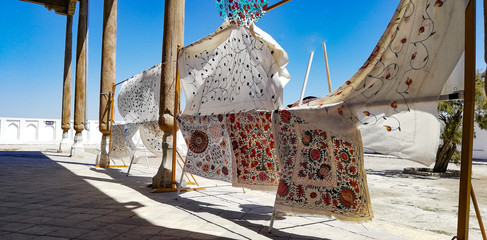 Carpets hanging in the streets of Bukhara in Uzbekistan. Sewn with floral motifs and pomegranates