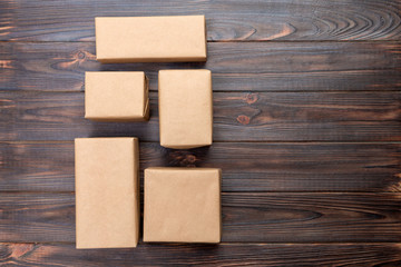 cardboard box on white wooden background, Brown mail package top view