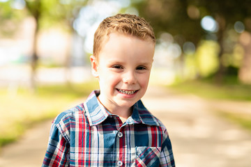 An nice adorable boy portrait outside standing