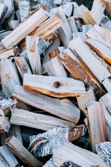 Fototapeta na wymiar Firewood background - chopped firewood on a stack. Dry chopped firewood logs in a pile.