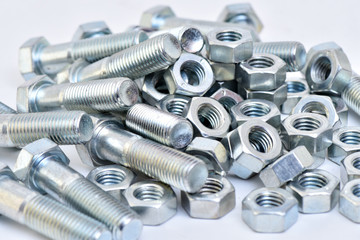 Fasteners on a white background. Manufacture of metal products.