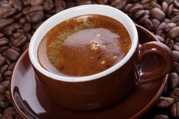 Cup of coffee with coffee beans, fresh brewed.