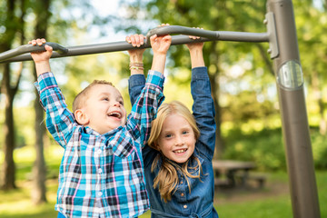 The Two young children having fun on the playground