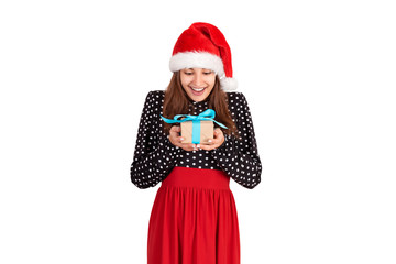 lucky girl in a santa claus hat is pleased to receive a gift. isolated on white background. holidays concept
