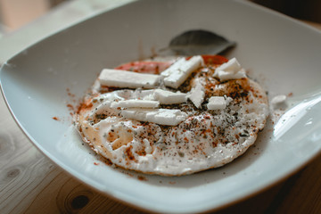 Fried eggs with cheese and spices