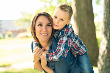 Fototapeta premium happy family mother and child son playing on autumn park