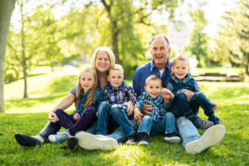 Fototapeta premium A Senior person with littleson on the grass