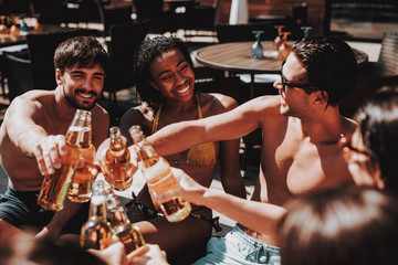 Young Friends with Alcoholic Drinks at Poolside