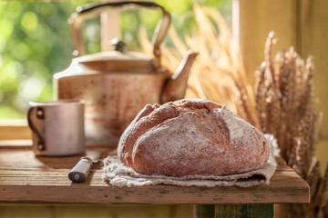 Fresh loaf of bread in spring sunny kitchen