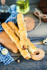 puff pastry roll with meat and cheese on a wooden board