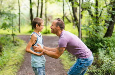 Father giving his son a piggyback ride, having fun