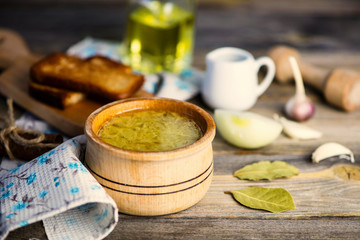 onion soup in a pot and croutons on a wooden board
