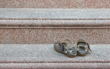 Old leather sandals on gravel staircase