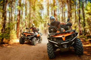 Wall murals Motorsport Two atv riders, speed race in forest, front view