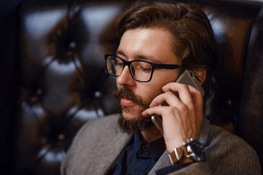 Close-up of a handsome talking on a mobile phone