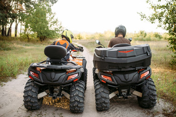 Two atv riders in helmets, back view, quad bike © Nomad_Soul