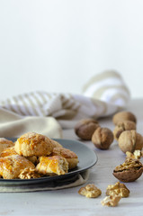 Shortcake of walnut on a wooden background.
