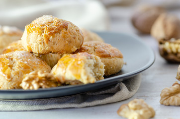 Shortcake of walnut on a wooden background.