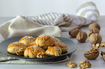 Shortcake of walnut on a wooden background.