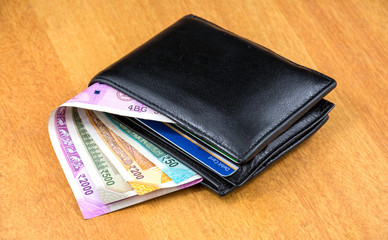 Indian Currency with Purse on a table