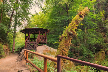 Summer house for tourists in green forest. Hiking trail near flowing Kamenice river in Bohemian...