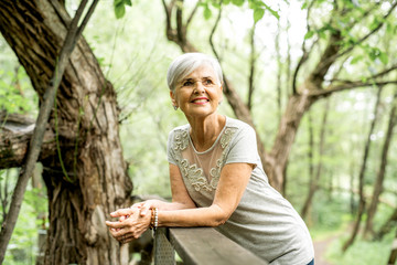 Senior woman in the nice forest park