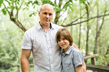 Obraz premium Father having fun in forest with his son