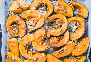 Pumpkin baked with herbs in tray.Roasted autumn vegetables healthy food.