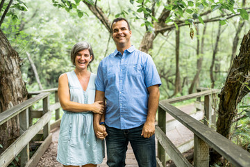 couple embracing each other having walk in the summer forest