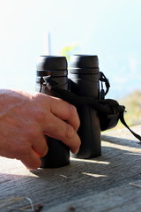 black binoculars with hand