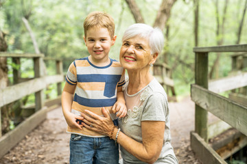 Fototapeta na wymiar Grandmother and grandson spend the weekend in the park