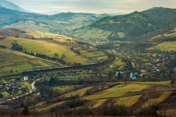 village in the valley. bird eye view. rail road and viaduct in the distance. mysterious autumn weather