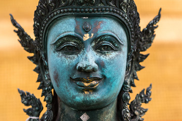The face of a statue, a part of the Golden Mount compound that belongs to an ancient Buddhist temple Wat Saket, Bangkok