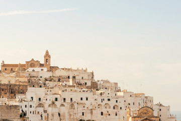 Fototapeta premium Panoramic view of the medieval white village of Ostuni at sunset
