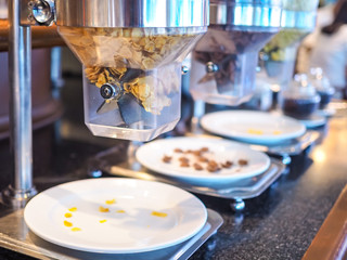 Cornflake or​ cereal​ dispenser​ on​ the​ counter​ bar​ in​ restaurant for those who stay in the hotel, take them for a buffet breakfast.