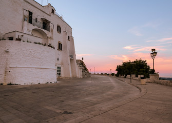 Walls of the medieval white village of Ostuni at sunset