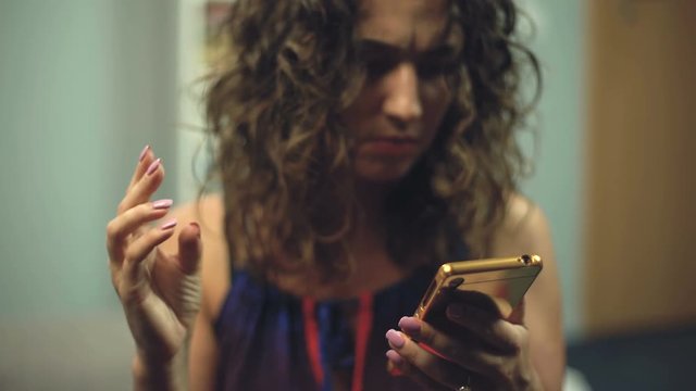 Disturbed woman searching something in phone trying to find mudra for meditation