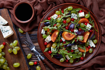 autumn salad with fruits, arugula, cheese