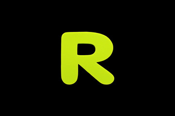 Alphabet letter R symbol of sponge rubber isolated over black background.