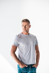 Obraz premium serious adult man in blank grey t-shirt looking away isolated on white