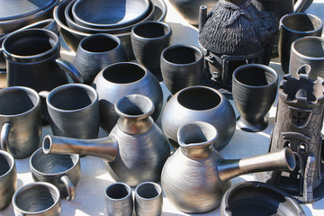 A jug and utensils with black clay.