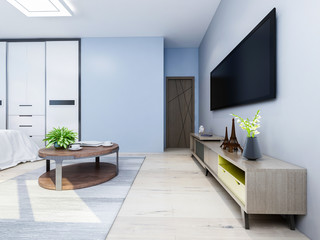 Modern bedroom with light blue walls with double bed, table, TV, wardrobe and greenery