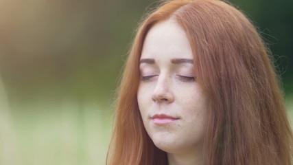 Woman faithfully closes eyes feeling gratitude to God Universe, gentle female