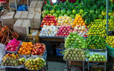Fruit shops in the market with all kinds like: tangerines. pomegranate, orange, apple, pear, grape, mango, dragon fruit, lychee ... all Arranged on shelves look attractive and eye-catching.