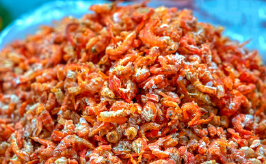 Fototapeta na wymiar Dried shrimp is sold at seafood market in Vietnam. Shrimp is dried and peeled and eaten with carrots during the holidays